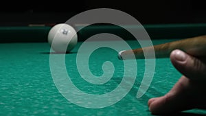 Play in Russian billiards close up. Cue hits white ball and it falls into pocket