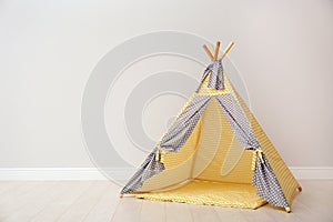Play tent for kids near white wall with space