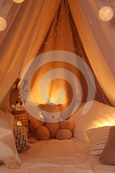 Play tent with toys and pillows indoors, closeup. Modern children`s room interior