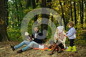 Play together. Mother father and small son play in park. Happy family with kid boy relaxing while hiking in forest