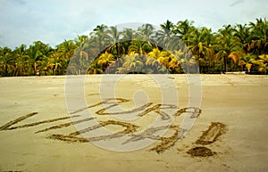 Carillo beach in Costa Rica with `pura vida` pure life written in the sand photo