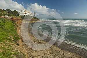 playa en el mediterraneo tras un temporal, con caÃ±as y maderas en la orilla photo