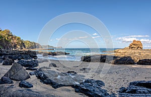 Playa Ocotal and Pacific ocean waves on rocky shore, El Coco Costa Rica