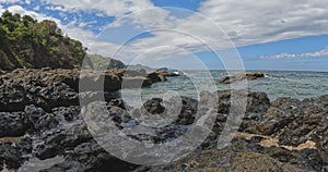 Playa Ocotal and Pacific ocean waves on rocky shore, El Coco Costa Rica