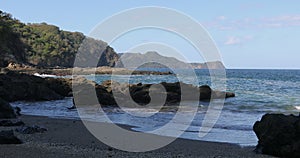 Playa Ocotal and Pacific ocean waves on rocky shore, El Coco Costa Rica