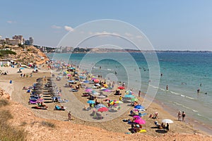 Playa Vistamar beach Mil Palmeras Costa Blanca Spain with people sunbathing on the beach photo