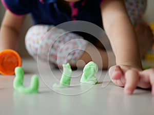 Playdough for baby being played on the house floor