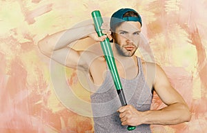 Player with confident face plays baseball. Sports and baseball training concept. Guy in grey tank top