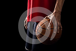 Player Holds a Basketball ball in one hand