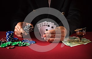 The player holds playing cards with a straight flush winning combination. Lucky win in a poker club game