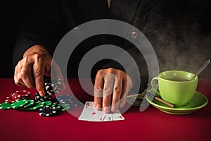 A player places a bet on a winning poker flush three of a kind or set of three aces. Luck or fortune in a poker club