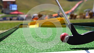 player play mini golf with red ball