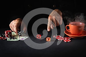 The player points his finger at the maximum in the winning combination when playing craps in a poker club. Luck or luck in the