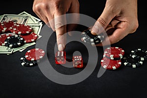 The player points his finger at the maximum in the winning combination when playing craps in a poker club. Luck or luck in the