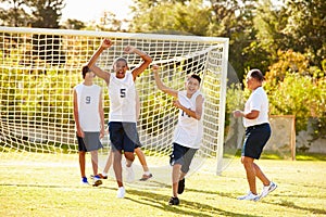 Player Scoring Goal In High School Soccer Match