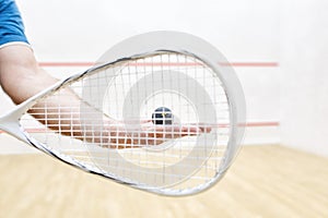 Player with squash ball and racket