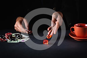 The player throws the dice on the table in the poker club. Luck or fortune in the casino