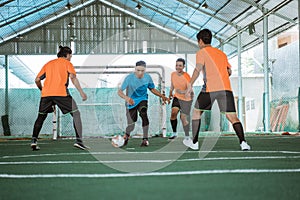 players in blue uniforms dribble past several opposing players