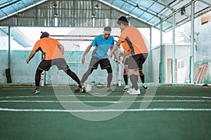 players in blue uniforms snatch the ball from opposing players