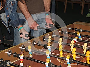 Players at Foosball Table