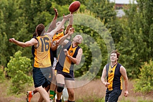 Players Jump To Catch Ball In Australian Rules Football Game