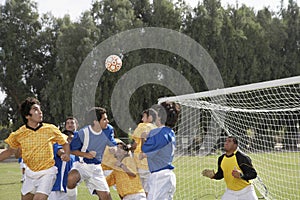 Players Playing Soccer On Field