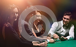 Players sitting at the playing table in the casino