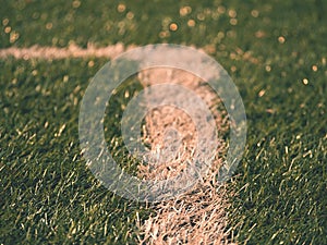 Playfield border. Closeup view to white lines on football playground. Detail of a of white lines