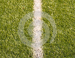 Playfield border. Closeup view to white lines on football playground. Detail of a of white lines