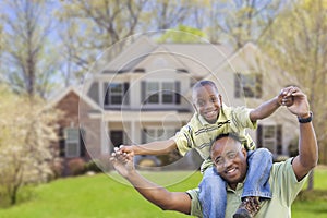 Playful African American Father and Son In Front of Home