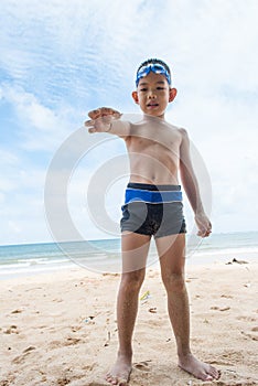 Playful boy and Hermit crab on the beach.