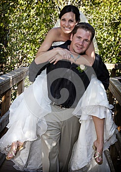 Playful Bride and Groom piggyback