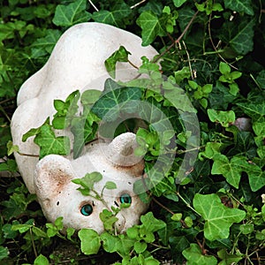 Playful cat garden figurine.