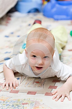 Playful child crawling on the carpet