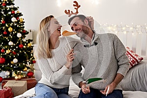 Playful couple having fun in Christmas time