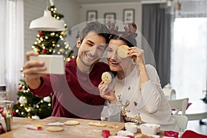 Playful couple making a selfie at Christmas