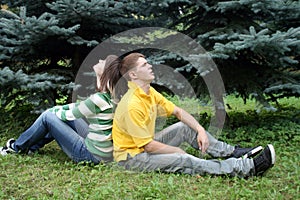 Playful couple sitting in park