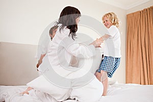 Playful family having pillow fight