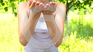 Playful girl blowing on hands with glitters in slowmo