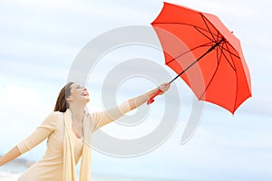 Playful girl joking with umbrella photo