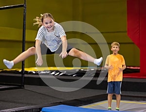 Playful girl jumping on trampoline at playground