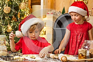 Playful holiday bakers. Funny Kids in kitchen making christmas cookies. Funny children are preparing gingerbread for