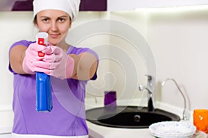 Playful housewife taking aim with the detergent