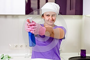 Playful housewife taking aim with the detergent