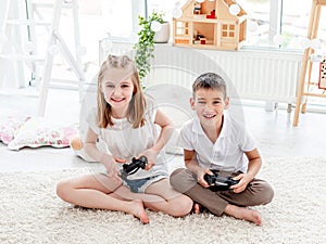 Playful kids with joysticks for gaming