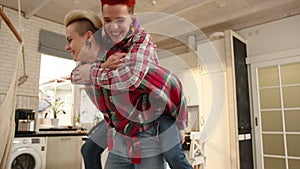 Playful Lesbian Couple Frolicking in Kitchen Enjoying Domestic Bliss