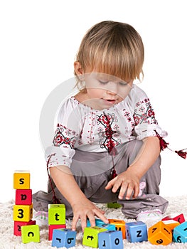 Playful little girl in embroided blouse