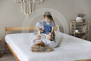 Playful little girl enjoy playtime with loving mother photo
