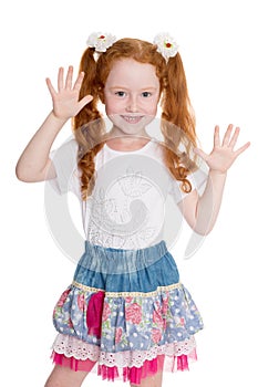 Playful little girl with hands raised