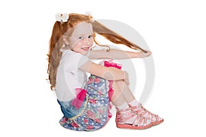 Playful little girl pulling her hair